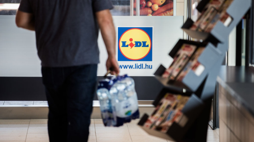 A customer carries a packet of bottled water inside a Lidl Ltd. grocery store in Vecses, Hungary, on Monday, June 4, 2018. Hungary is enjoying an upturn and the $130 billion economy may expand 4.1 percent in 2019, Finance Minister Mihaly Varga said in a recent interview. Photographer: Akos Stiller/Bloomberg via Getty Images
