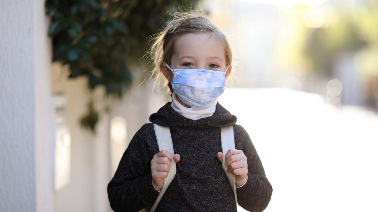 Child with protective face mask during COVID-19 pandemic