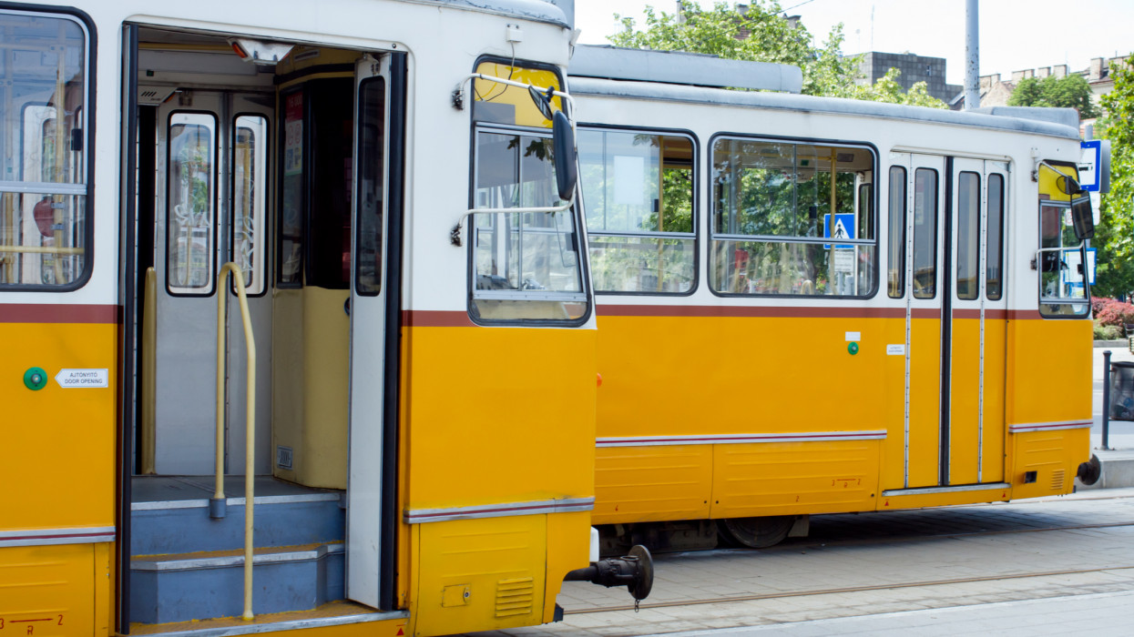 orange trams on the street of Budapest, Hungary