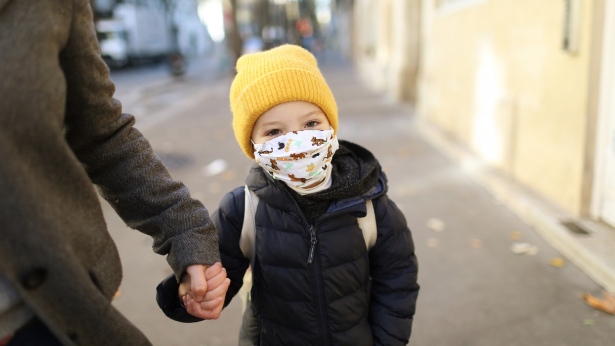 Child with protective face mask during COVID-19 pandemic