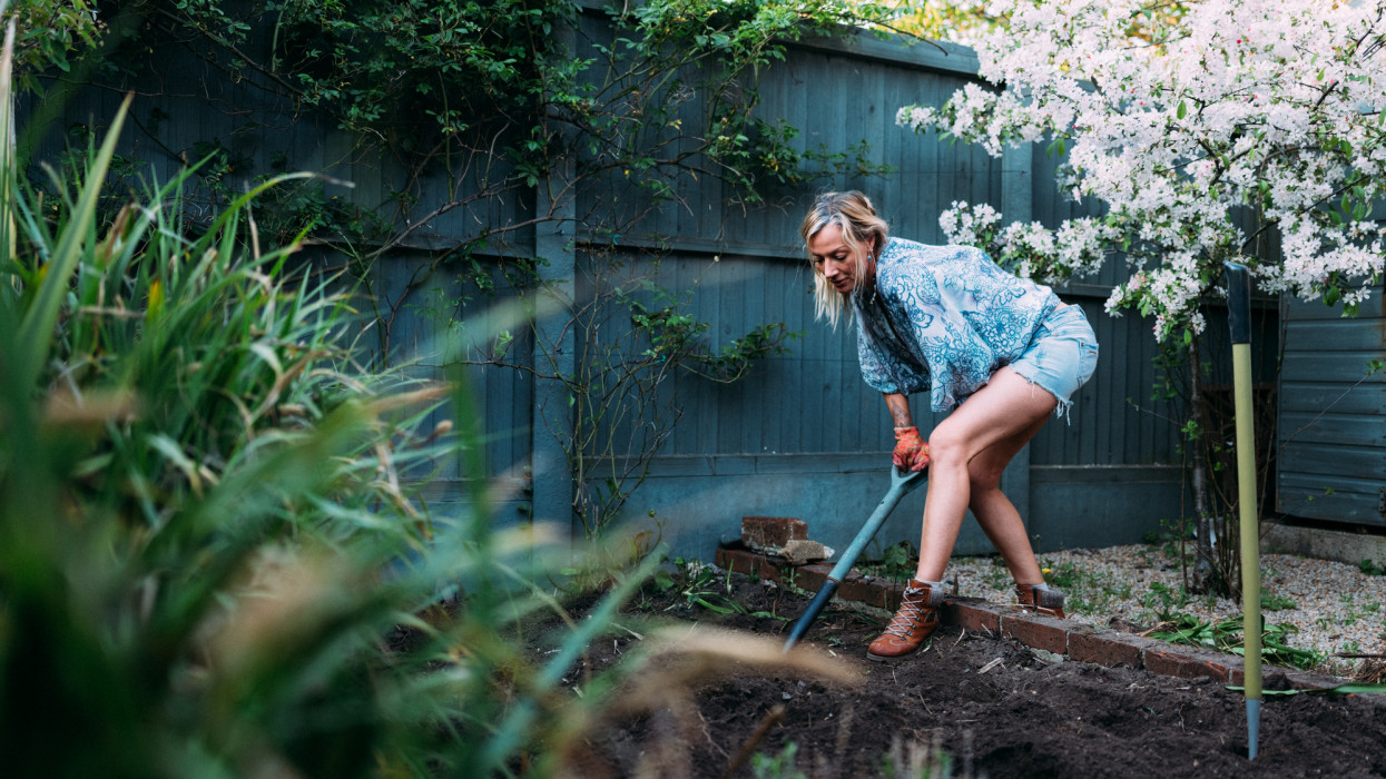 Blonde female adult gardening at home