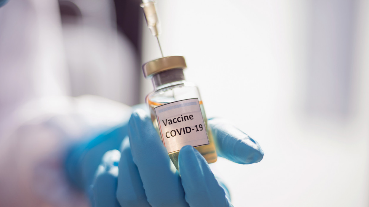 The Doctor using a Covid-19 and corona-virus vaccine vial and syringe