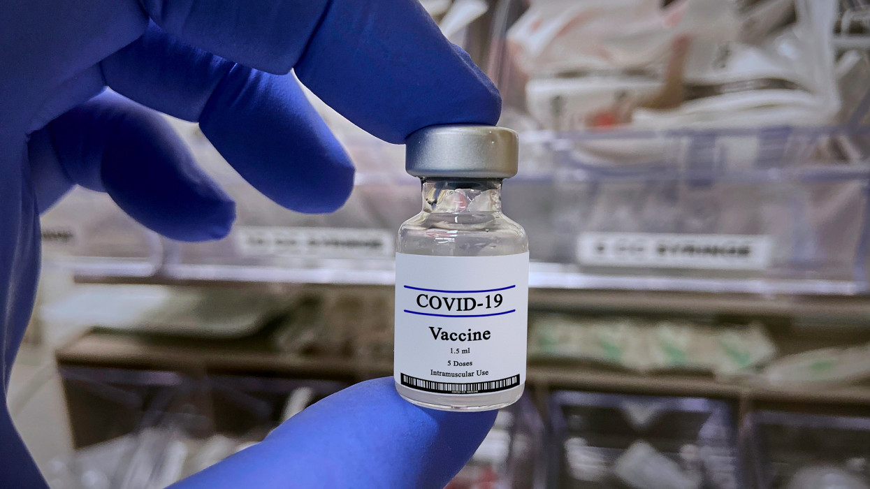 Close-up of COVID-19 Vaccine on nurse hands in medical environment. Newest research and development against coronavirus worldwide pandemic.