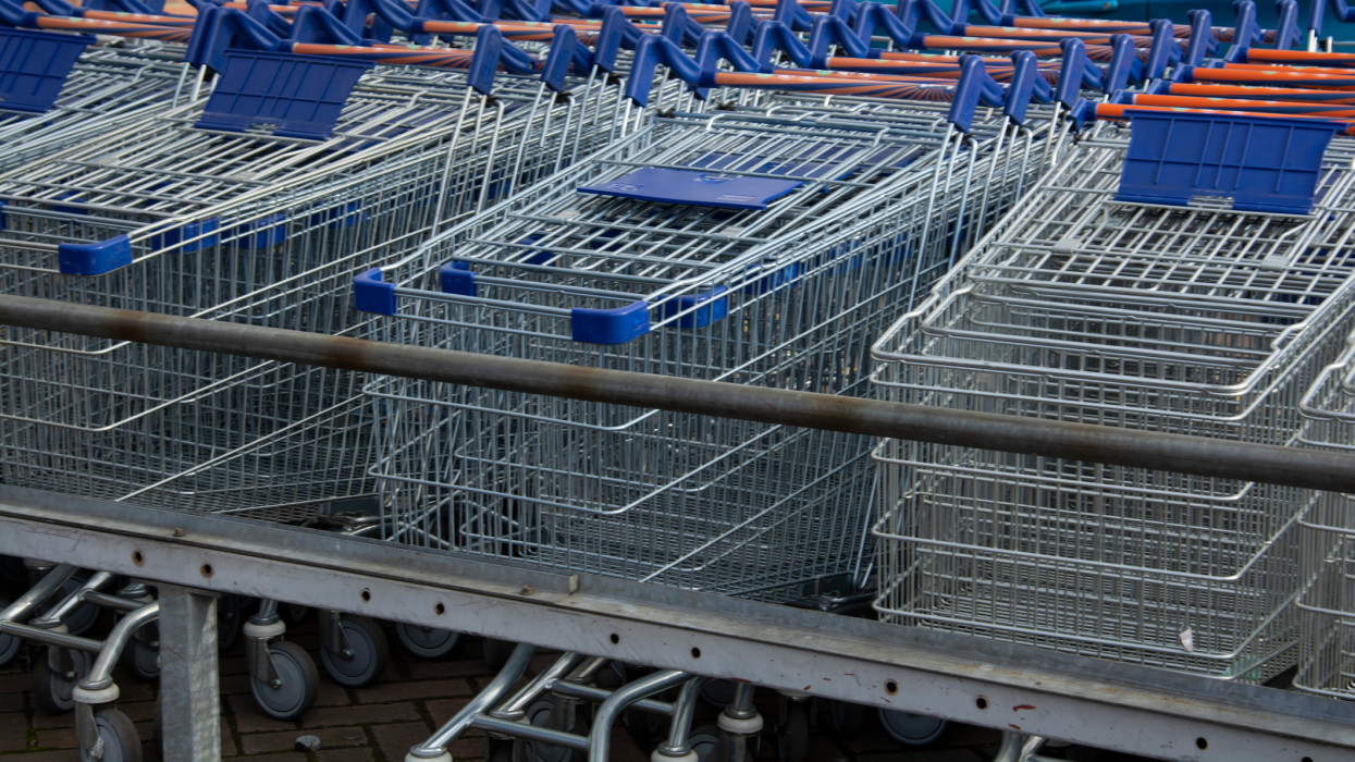 Corby, U.K, 19 March 2019 - A long row of shopping trolleys carts at Asda Shop, outside of a large supermarket. Shopping.