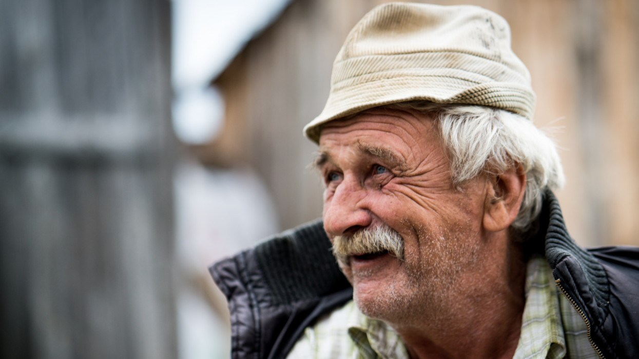 Elder senior man portrait with mustache in cap cimlapi