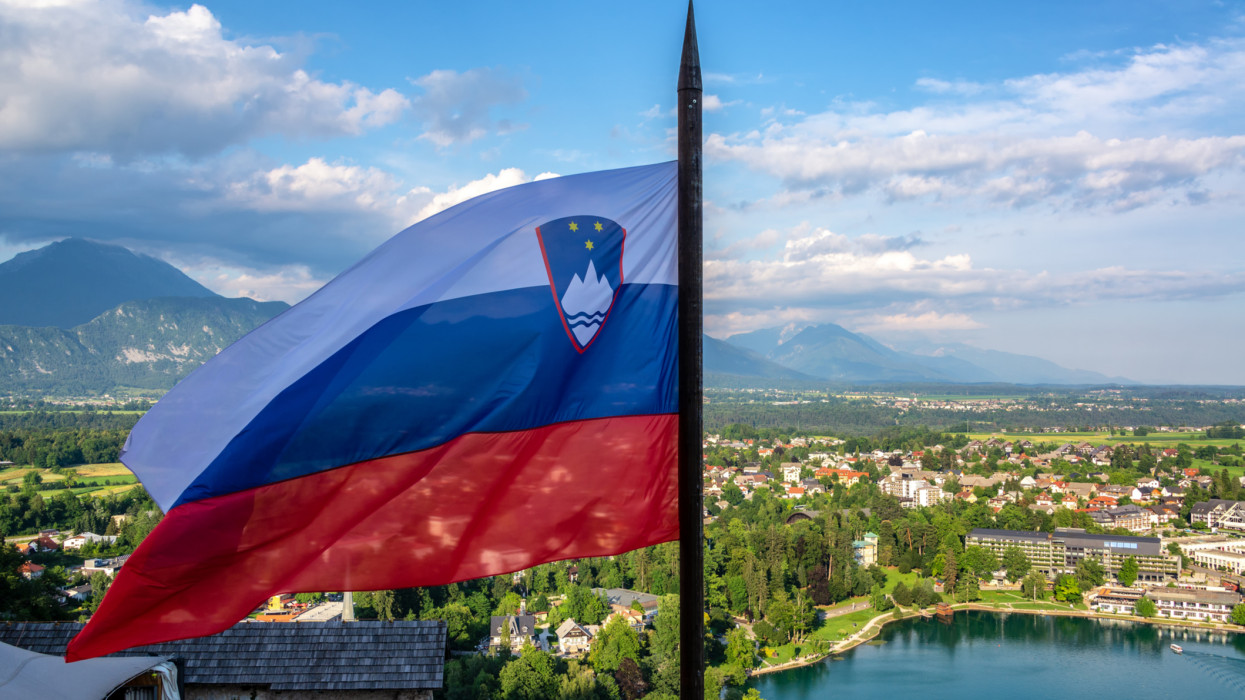 Slovenian flag flying high over Lake Bled in Slovenia
