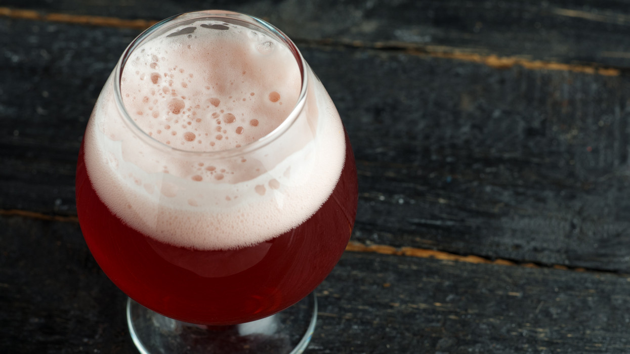 A glass of unfiltered cherry beer