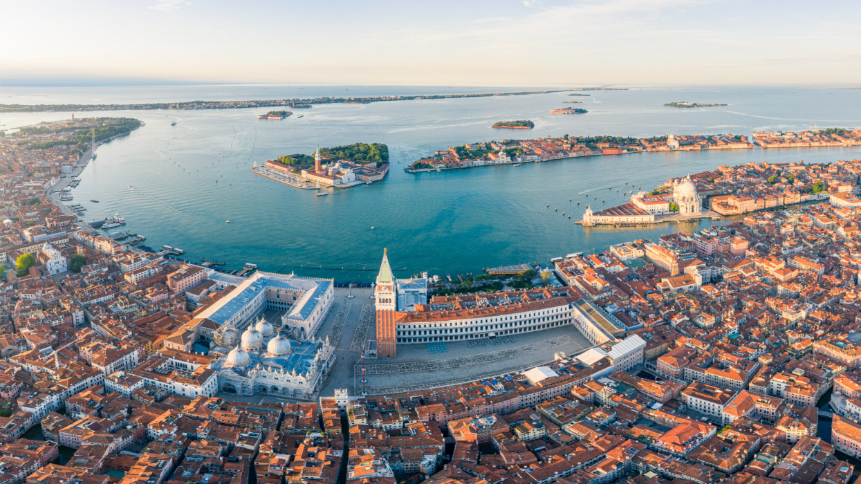 Italy, Veneto region, Venezia: aerial view of St.Marks square, with the islet of San Giorgio Maggiore in the background, at sunrise.