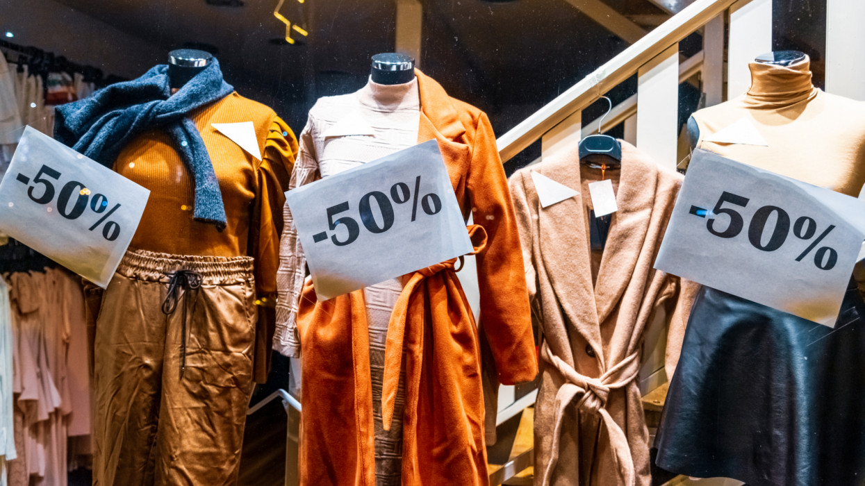 Half-priced womens clothes in a shop window. cimlapi