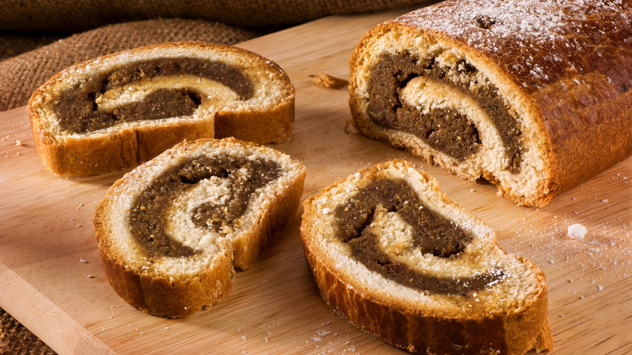 Traditional Hungarian folk cake xmas walnut rolls on a wooden cutting board