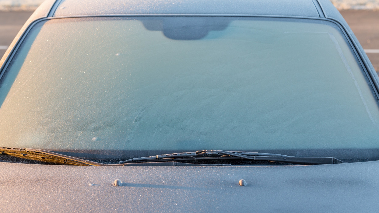 Frosty patterns on a completely covered car windscreen