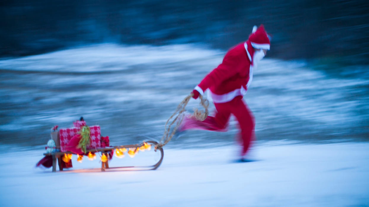Santa Claus Hurrying To Deliver Christmas Gifts. last minute