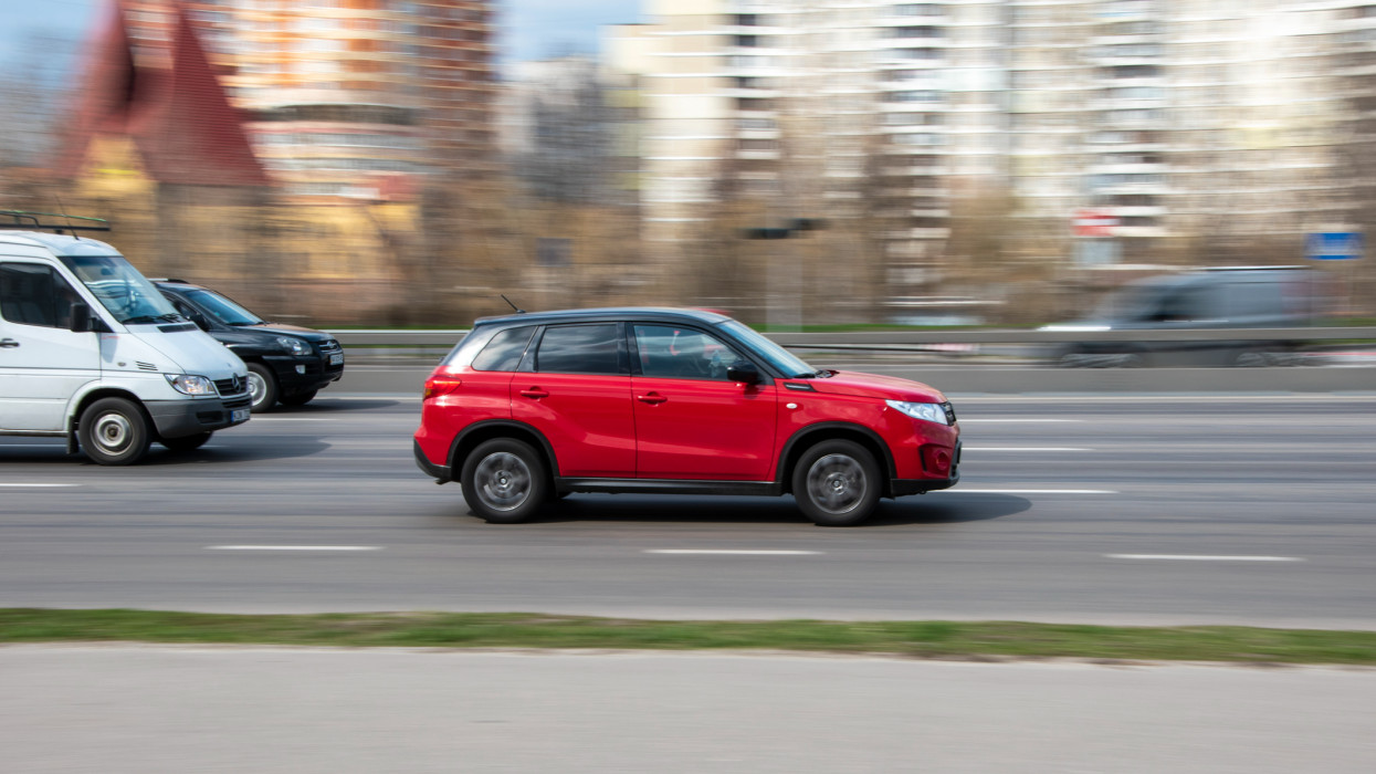 Ukraine, Kyiv - 6 April 2021: Red Suzuki Vitara car moving on the street. Editorial