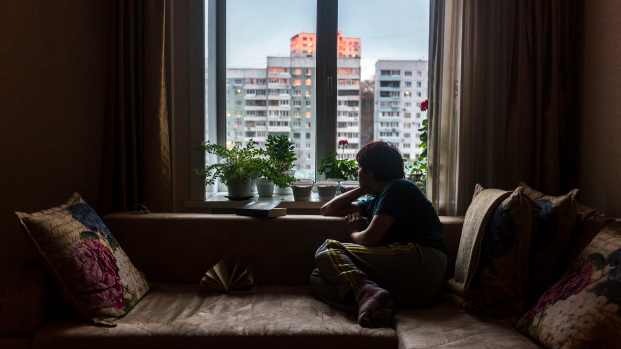 A woman in Vladivostok, Russia looks out of the window at road outside her apartment in the times of corona virus. Quarantine has forced many to spend a lot of time indoors often leading to lethargy due to lack of physical activity and even depression and other psychological conditions.