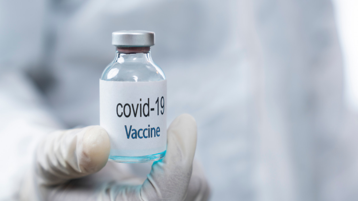Coronavirus COVID-19 vaccine. Doctor holding Corona virus vaccine and syringe using for prevent COVID-19 infection. Medicine and Healthcare concept.n