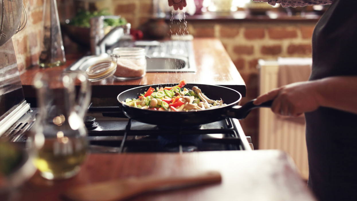 Cooking vegetables in real, rustic kitchen. Natural light, short DOF, a little bit noisy.