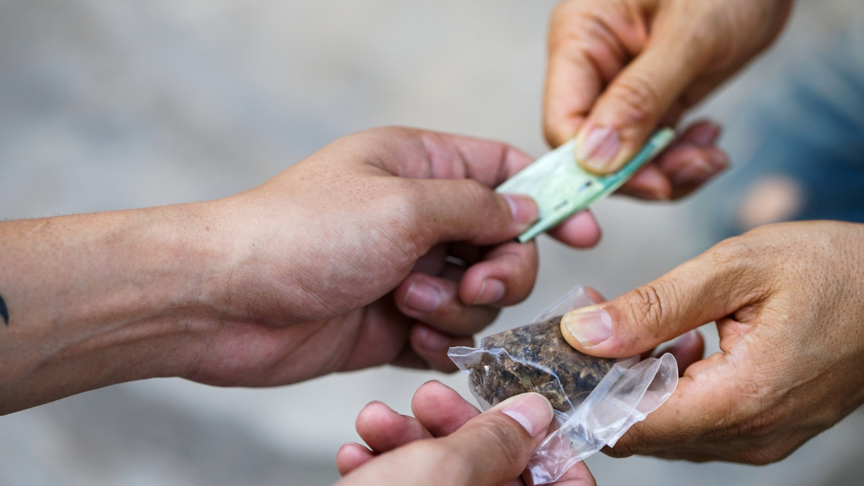 Drug addict buying narcotics and paying,Drug trafficking