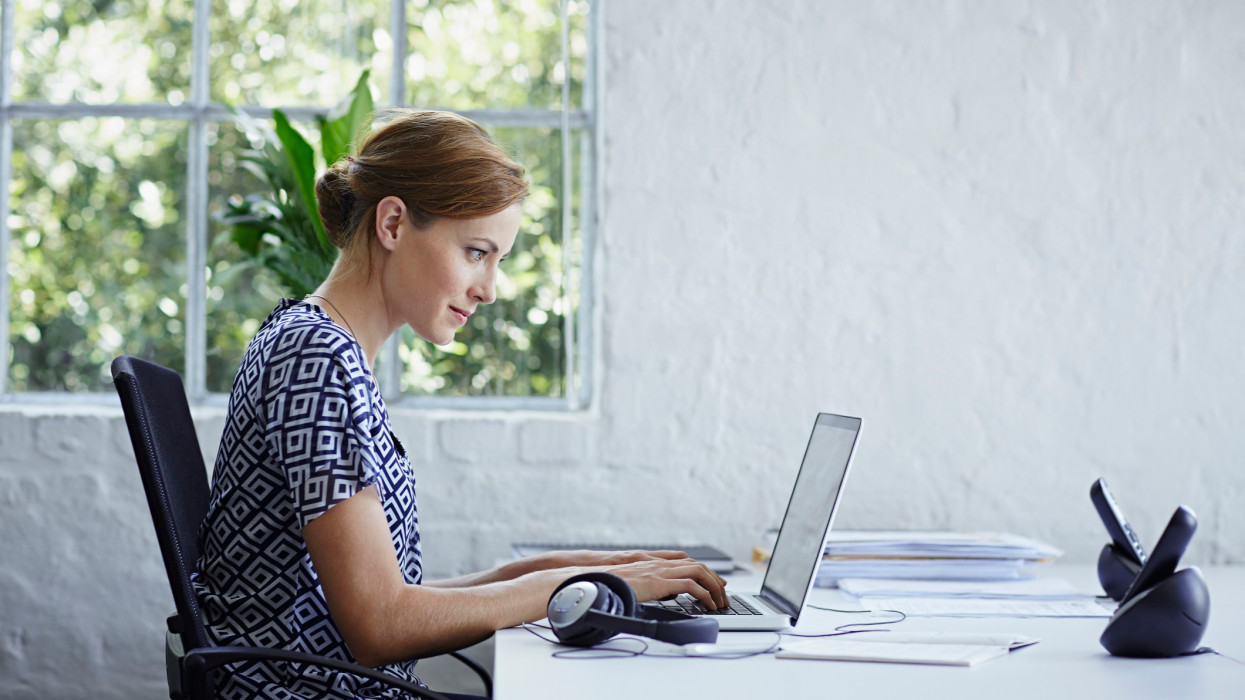 Woman working on computer replying to emails