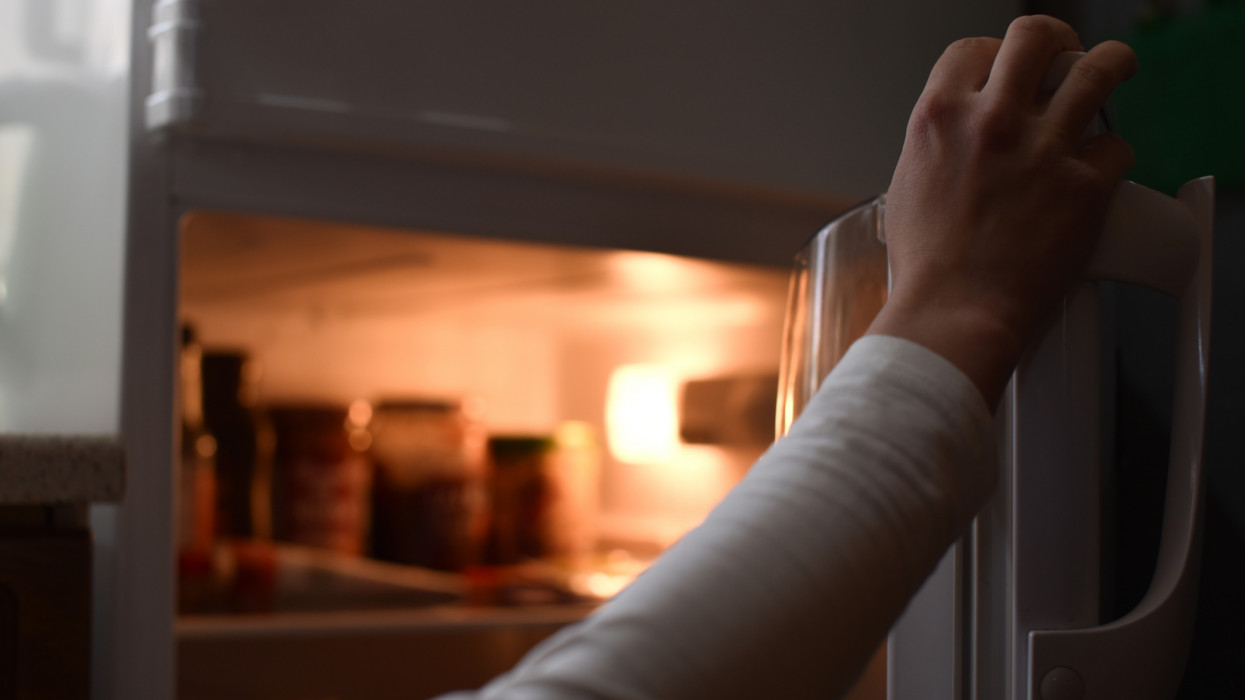 Hand opening fridge