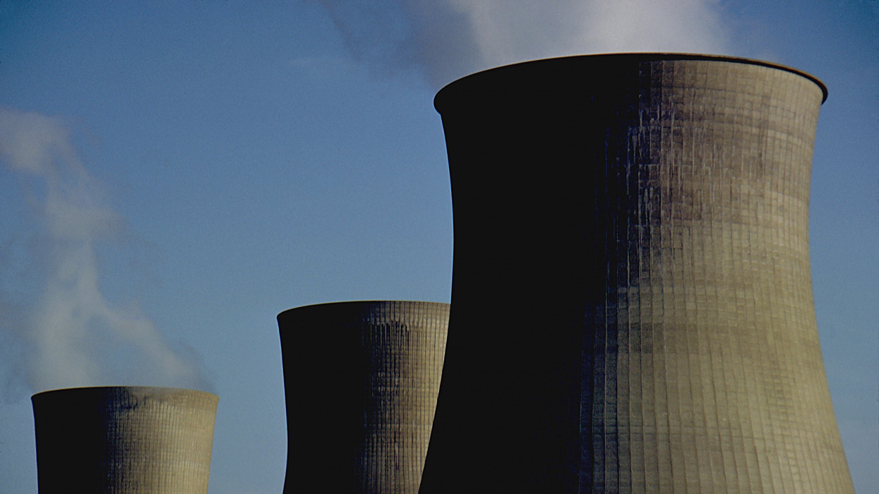 These are the iconic cooling towers of a nuclear power plant. these oversized smoke stacks vent steam form the Power plantThese were shot in Winfield, West Virginia, USA. The Image has a ominous vibe.