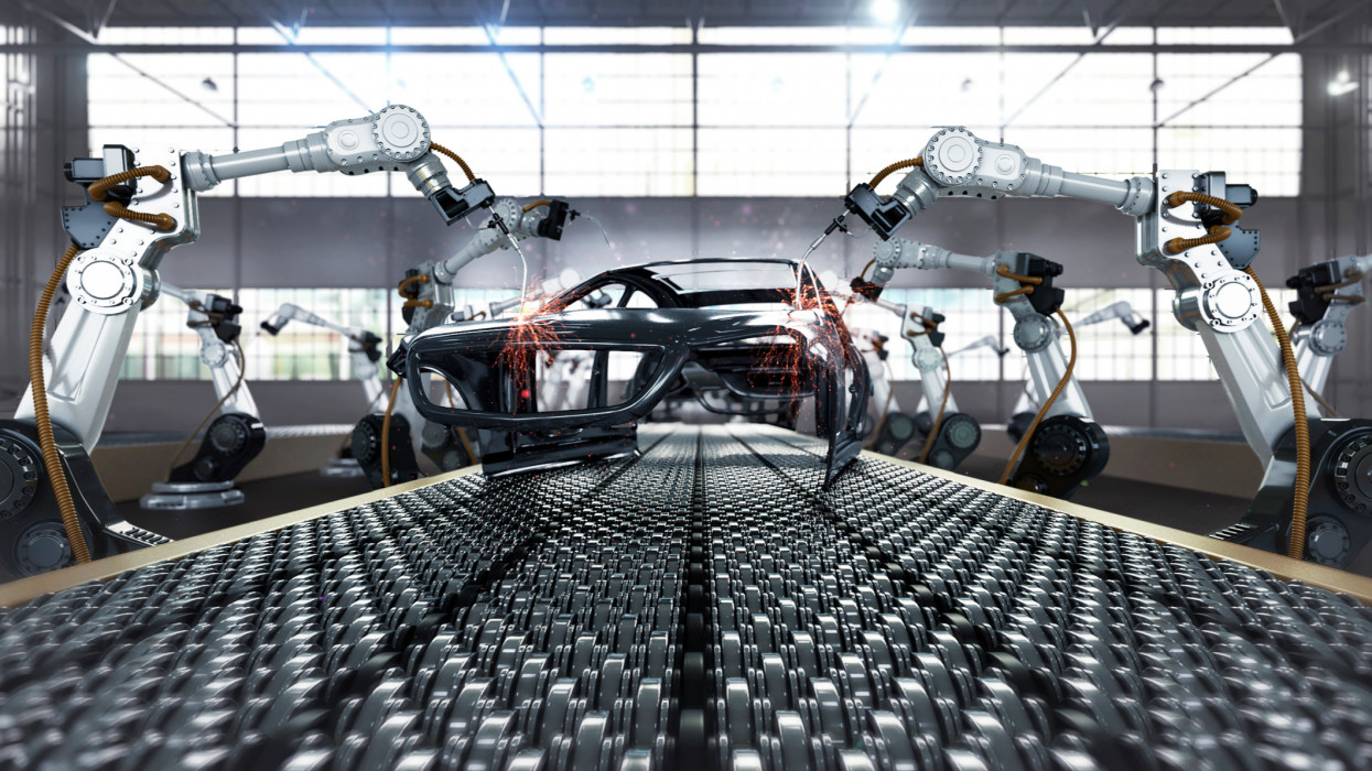 Robotic arm welding the car in assembly automobile manufacturing plant.