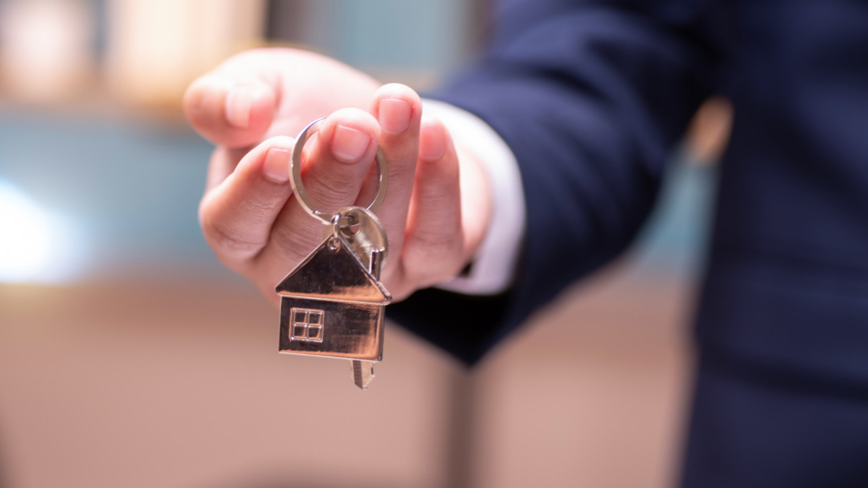 Home concept,Businessmen holding home keys