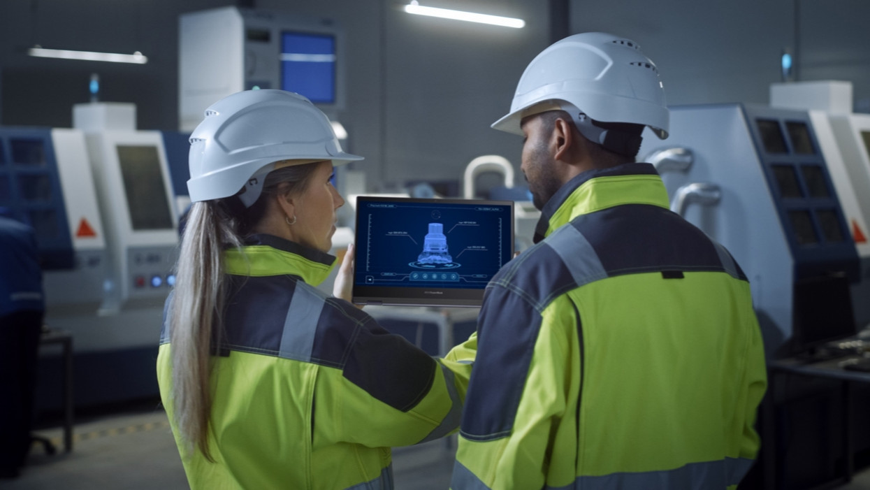 Industry 4.0 Factory: Chief Engineer and Project Supervisor in Safety Vests and Hard Hats, Talk, Use Digital Tablet Computer with Green Screen, Chroma Key. Workshop with Machinery.; Shutterstock ID 1902078538; purchase_order: -; job: -; client: -; other: -
