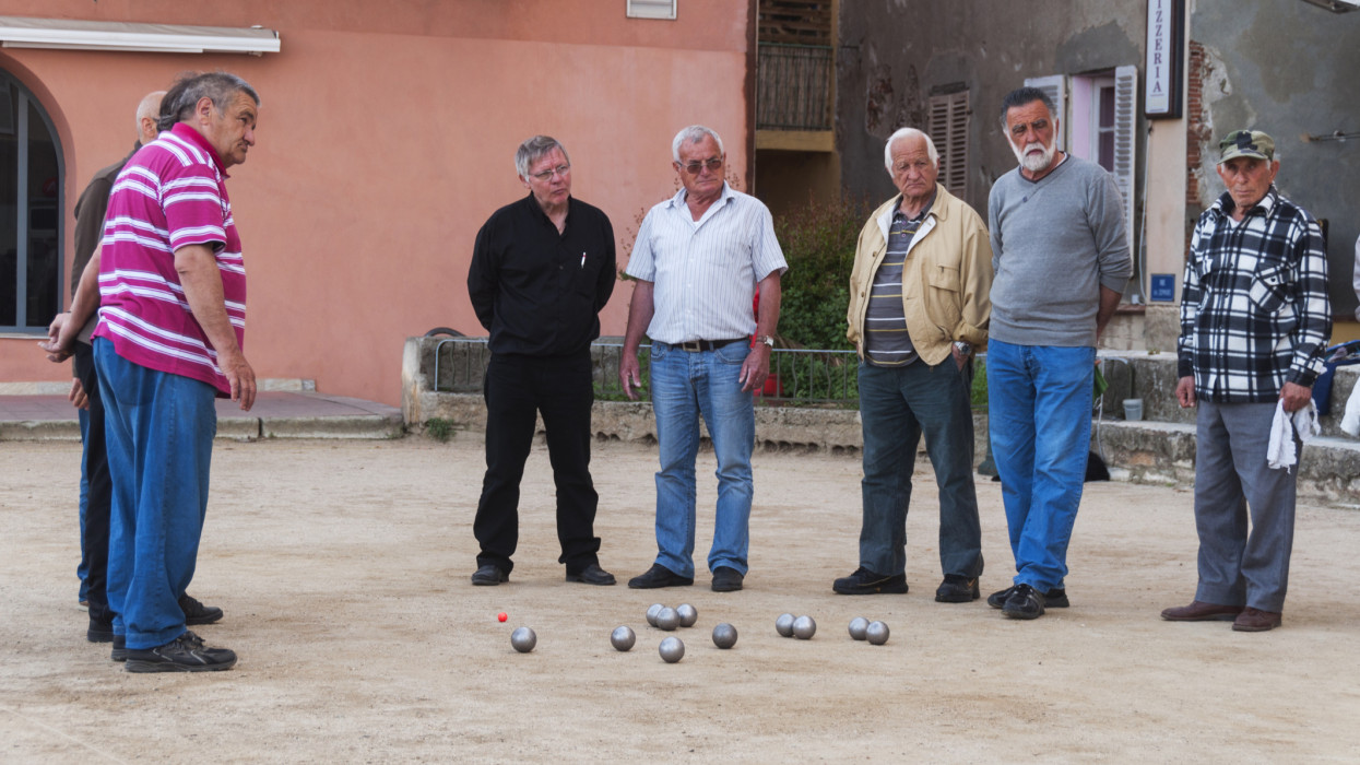 France, Corsica, Bastia, men playing game of petanque