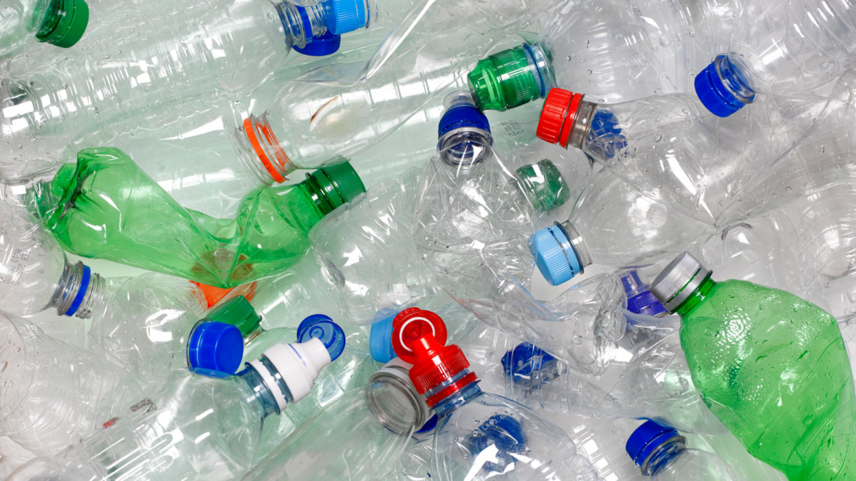 discarded used water bottles in recycling bin.  The lids can be recycled as well if reattached to the water bottle