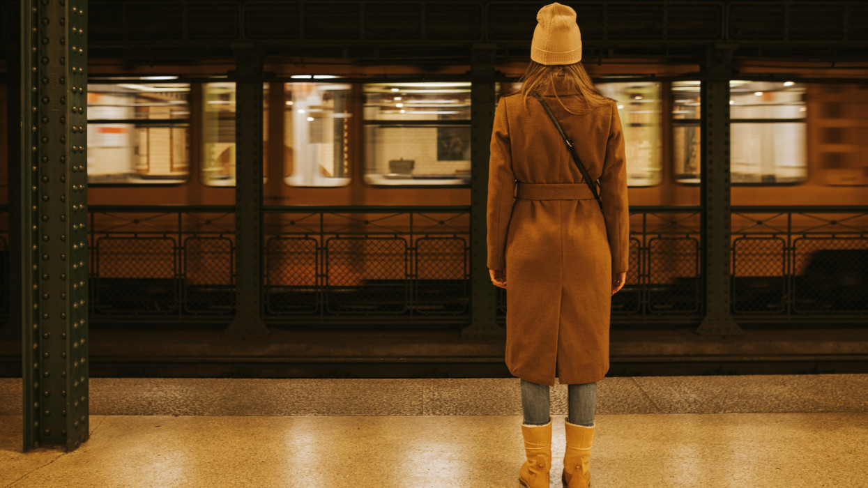 Woman standing in empty subway station