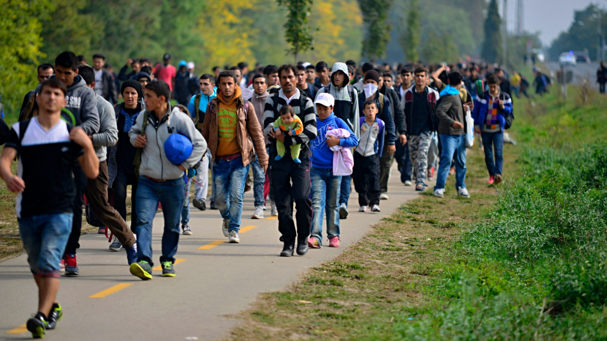 Hegyeshalom, Hungary - October 6, 2015:  Group of refugees leaving Hungary. They came to Hegyeshalom by train and then they leaving Hungary and go to Austria and then to Germany. Many of them escapes from home because of civil war. ukraine war