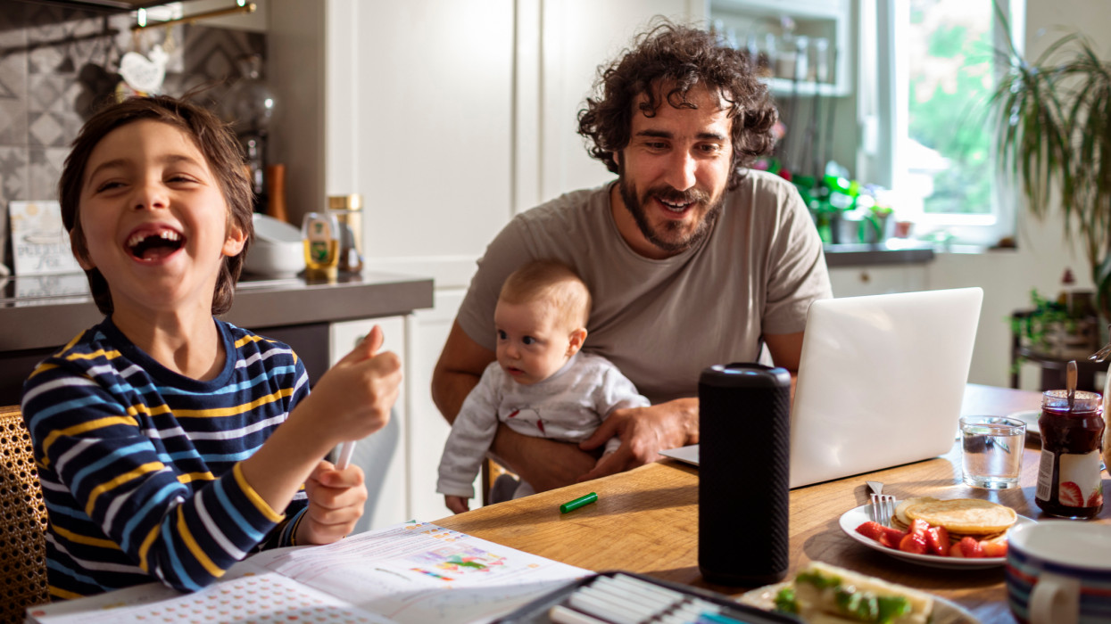 Close up of a young family using a smart speaker while having breakfast in the morning