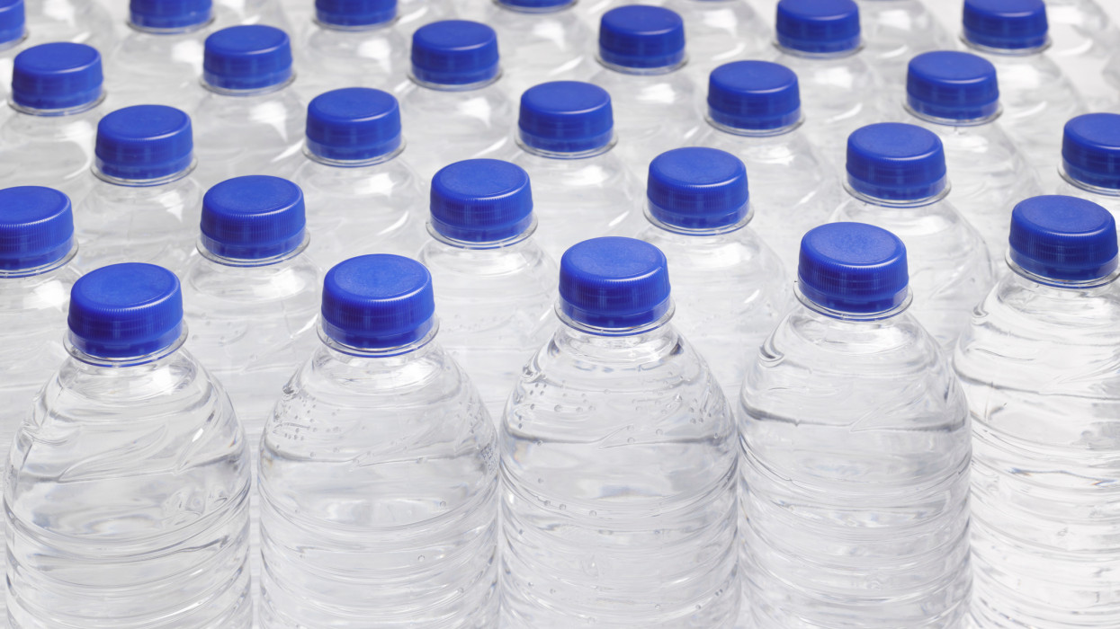 Full frame of still water bottles in rows