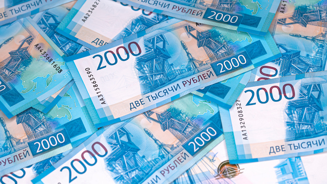 Background of banknotes of two thousand Russian rubles in a blue design laying on a surface