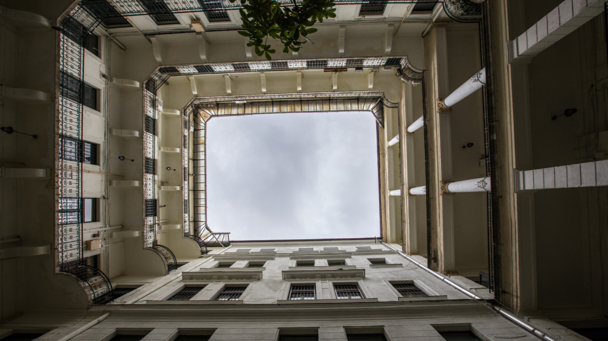 A typical living quarters in the centre of Budapest, the Capital of Hungary in Central Europe.  Looking up at the rectangular format of the building.