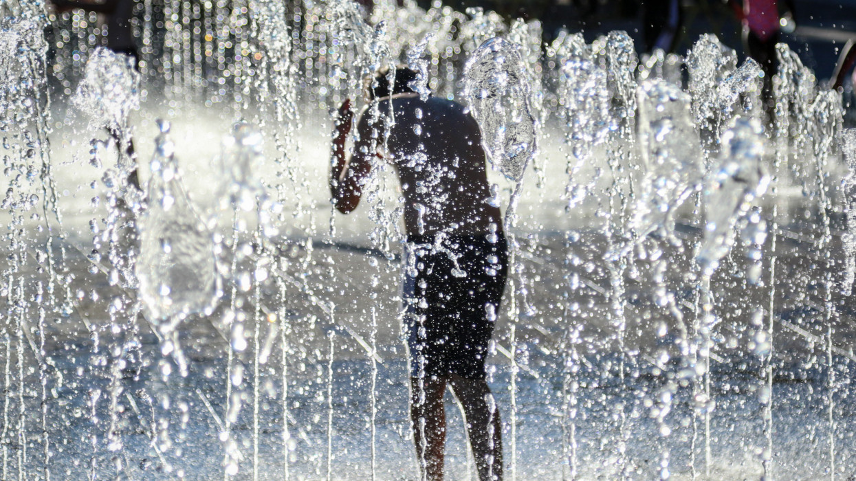 A boy plays in the shower fountain at Granary Square, London