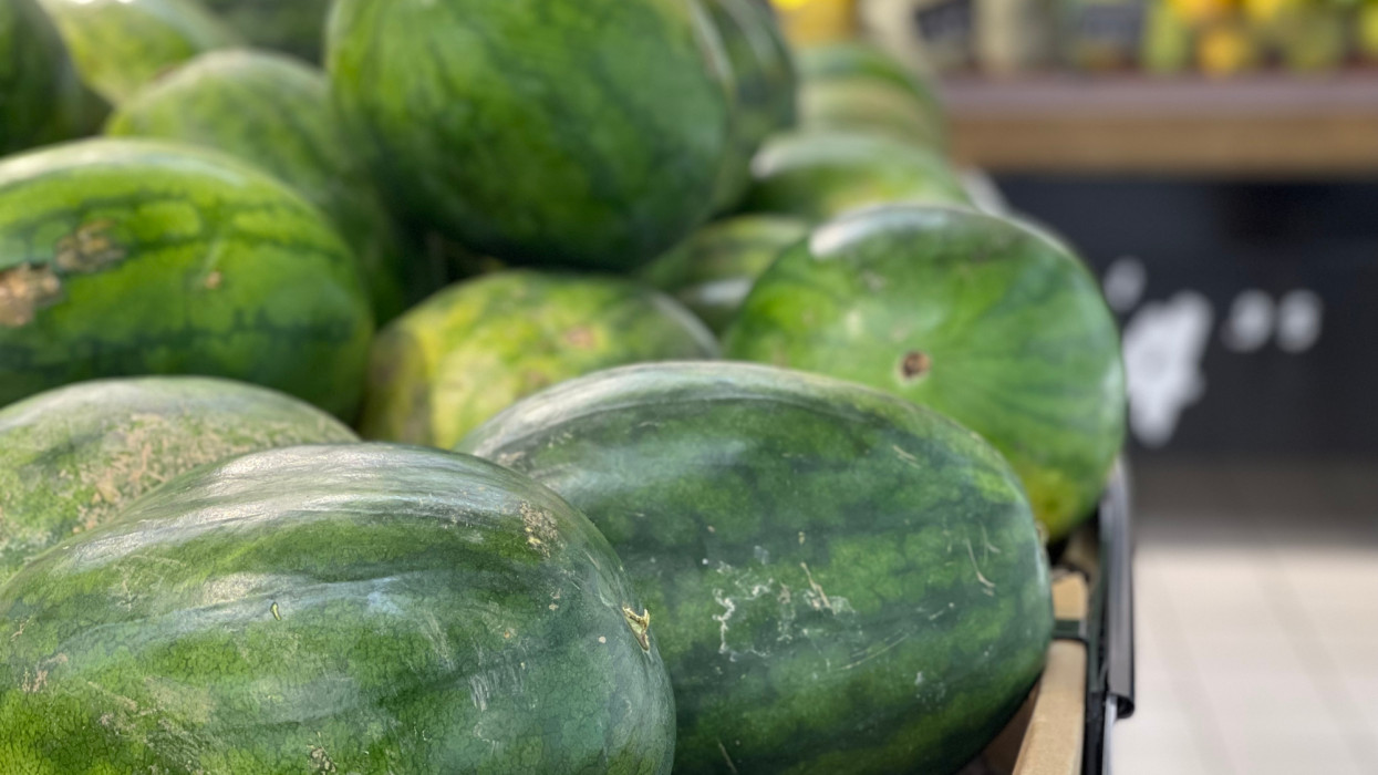 Close-up if a heap of watermelon for sale in retail fruit farmers marketplace
