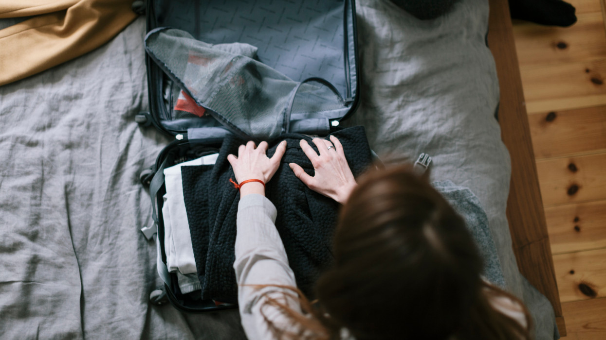 Woman packing a Suitcase for a Trip
