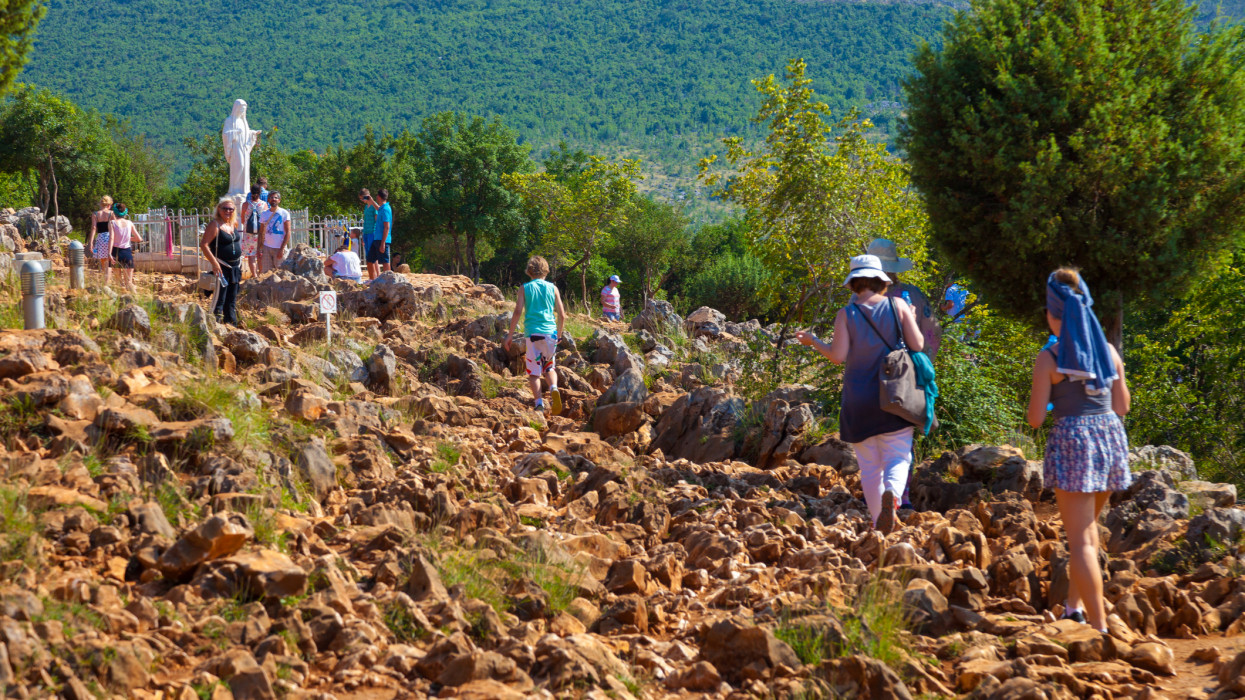 Medjugorje, Bosnia and Herzegovina - July 20, 2014: Unidentified pilgrims coming up the hill where Blessed Virgin Mary appeared to six children in June 1981.