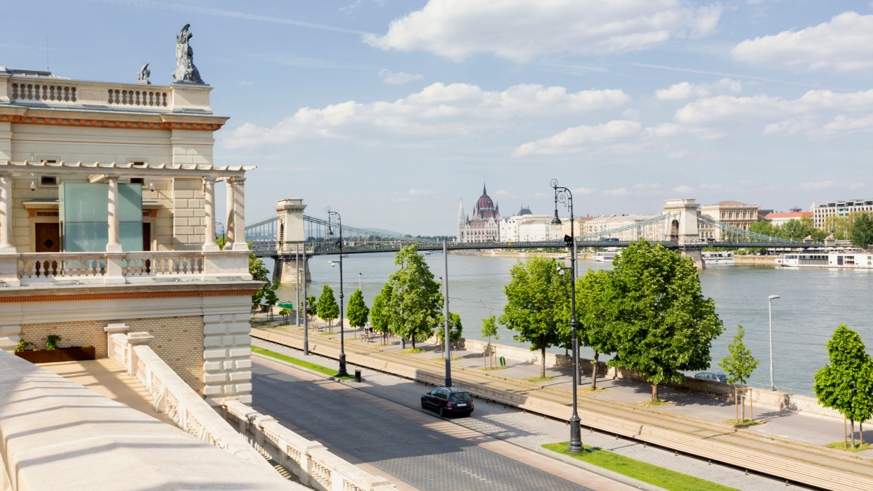 View of the Chain Bridge and Hungarian Parliament as seen from the restored neo-Renaissance building complex VÃ¡rkert Bazaar in Budapest.