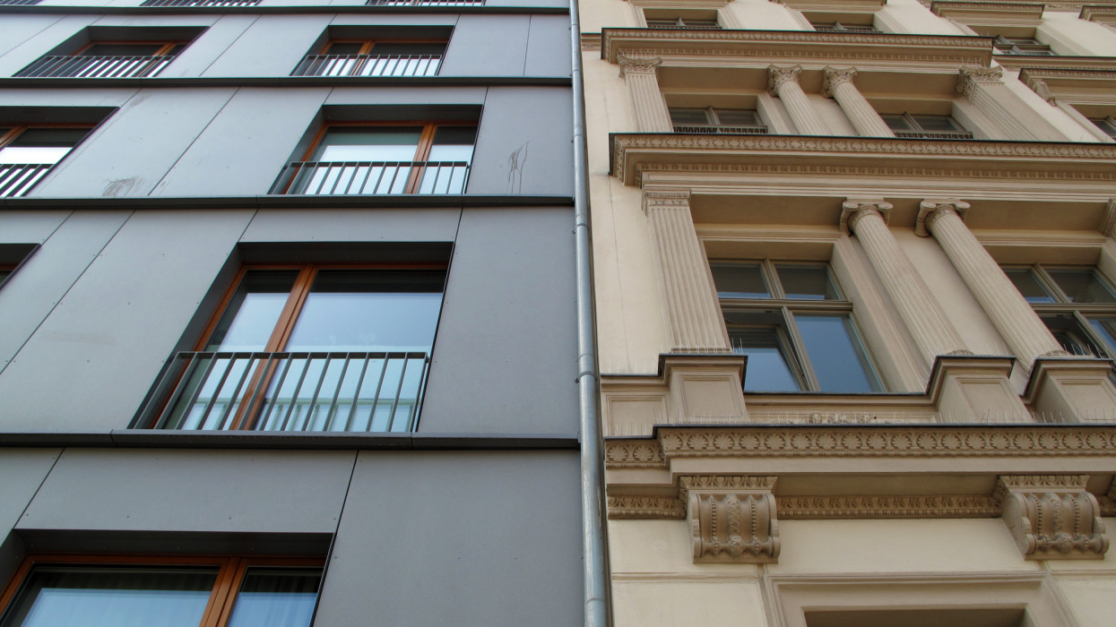 Contrast between new residential housing and ornate old pre-war residential building in the district of Mitte, Berlin, Germany