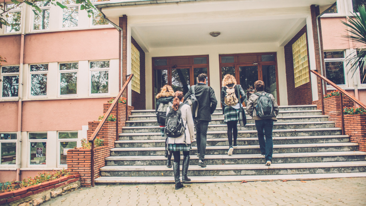 Five Turkish students walking to school. They are ascending the staircase, outdoors, campus. Cold autumnal morning. Nikon D800, full frame, XXXL.