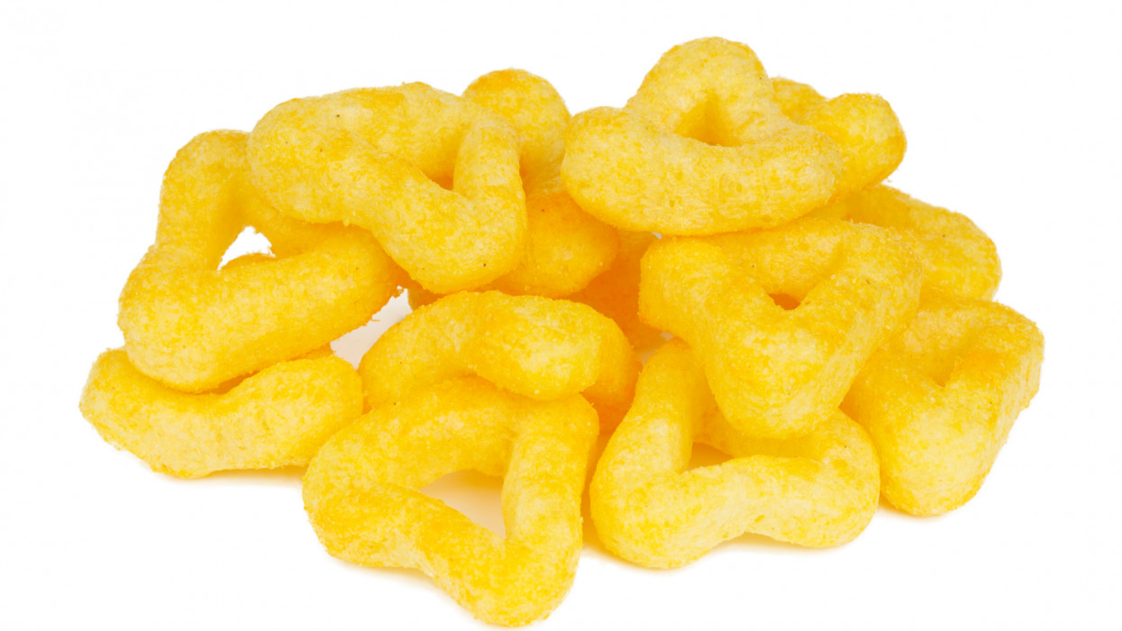 Crispy cheese snacks on a white background, salted corn rings.
