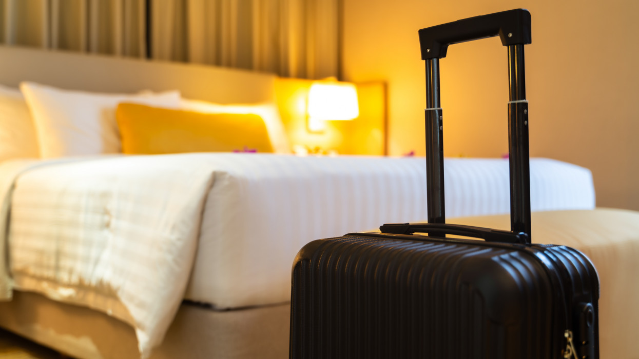 Suitcase delivered standing in hotel room. concept of Hotel service and travel
