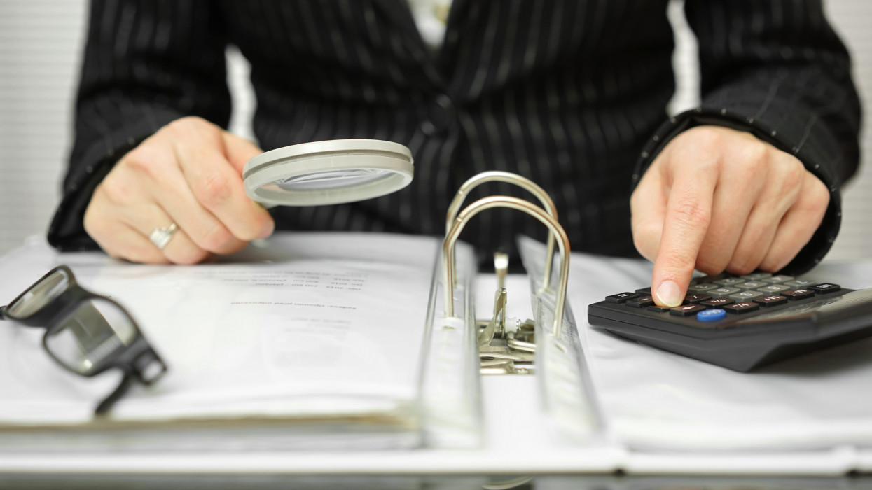 accountant is examining  invoices and documents