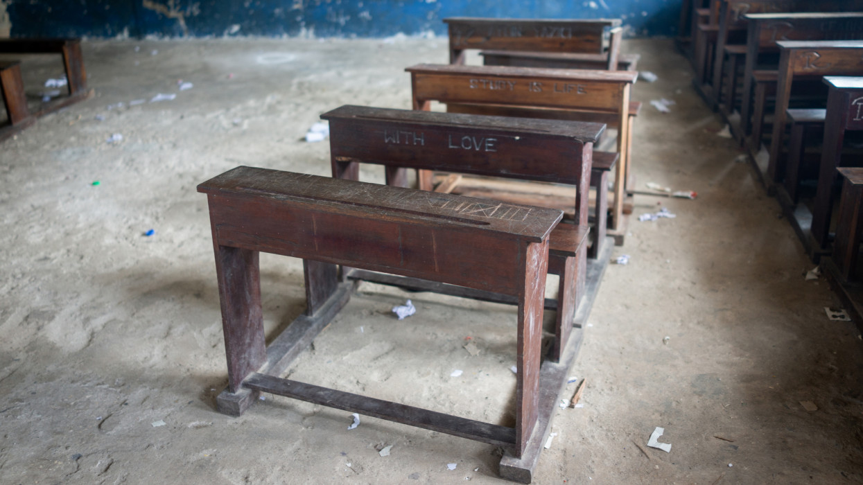 Old poor school classroom in Africa with charity gift chairs and desks