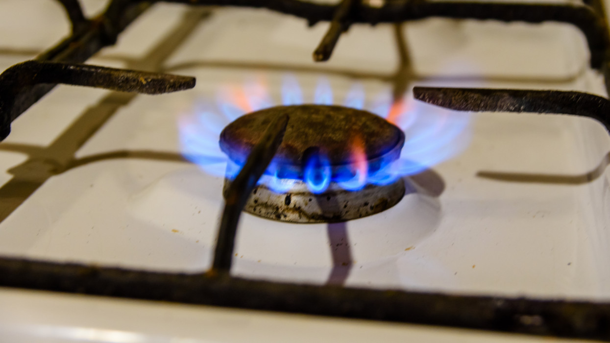 Gas burner on a white kitchen stove flame cooking