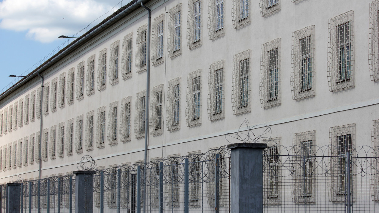 Prison building with razor wire fence