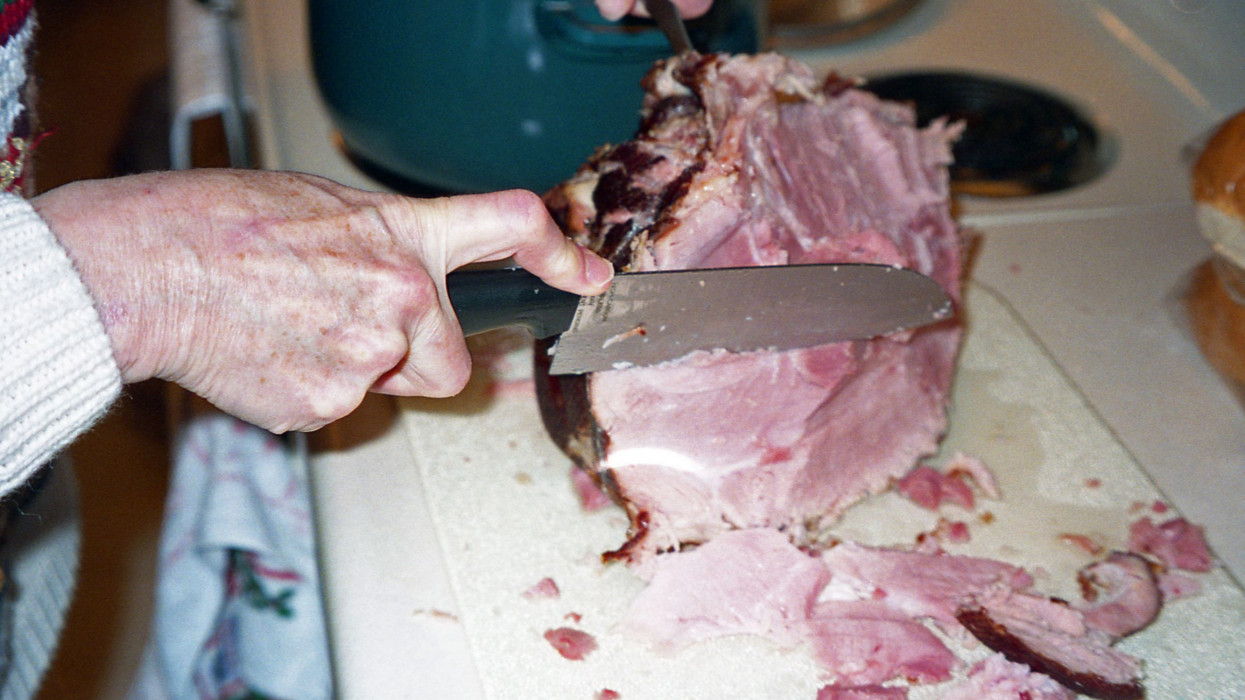 slicing ham on a cutting board