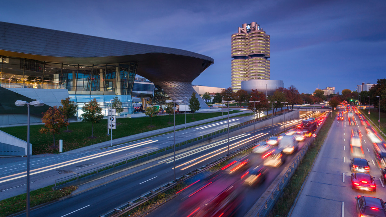 Germany, Bavaria, Munich, BMW Welt company showroom, BMW company headquarters and BMW Museum with evening traffic